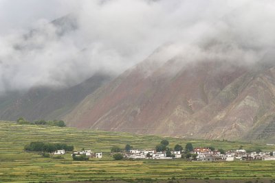 Morning fog lifts above a small village