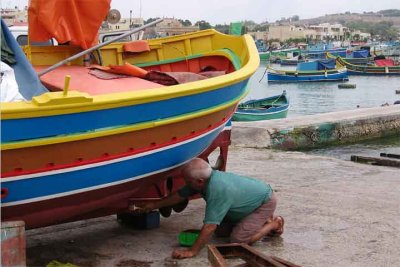  A fisherman painting his boat