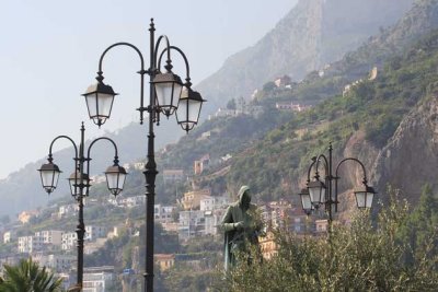 Lamps, statue against Amalfi coast backdrop.We took a bus to Positano......