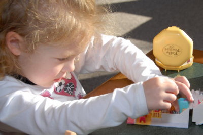 Ellie playing with Natalie's Polly Pockets