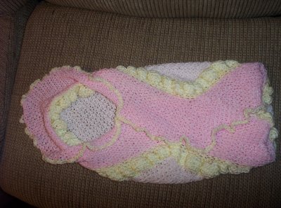 A picture showing that (original) blanket folded as if a baby were swaddled in it.