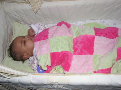 The gift recipient (Nicole) asleep on her pillow and covered with the blanket.  (Her Mom says that every night she's covered with this blanket at bedtime.)