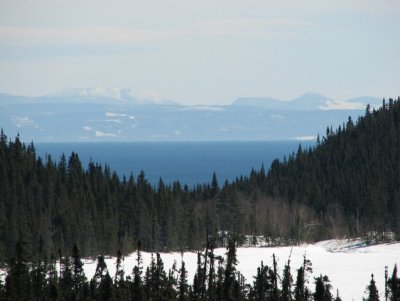 A lake in the foreground, the St. Lawrence River and the Gaspe region in the background