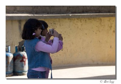 2 girls playing with cameras