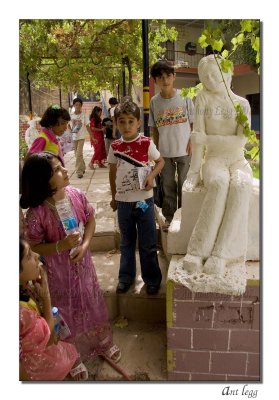 children and statues in the garden