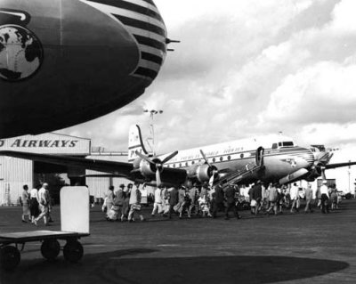 1949 - Passengers walking across the ramp to board a Pan American DC-4