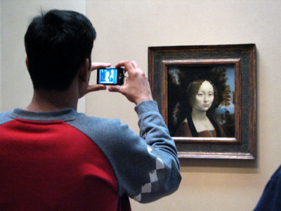 A tourist photographs the only Leonardo da Vinci painting in the Americas, National Gallery of Art, Washington, D.C.