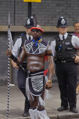 Carnival marcher and disinterested Bobbies