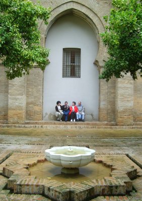 tourists resting in the moorish courtyard of the cathedral