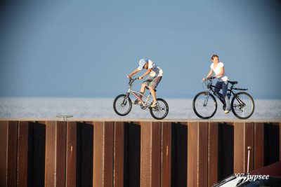 two kids riding on the seawall