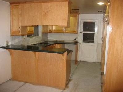 new counters, stained cabinets, cement floor.JPG