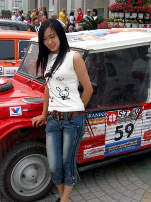 Girl posing in front of the cars