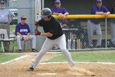 daniel watches a ball in the dirt