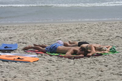 michael and alex asleep on the beach