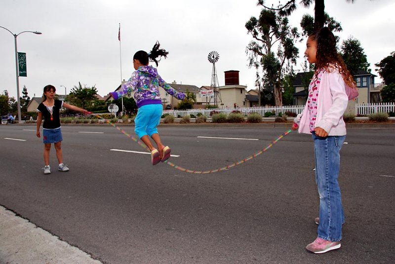 Children jumproping before parade