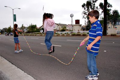 Children jumproping before parade