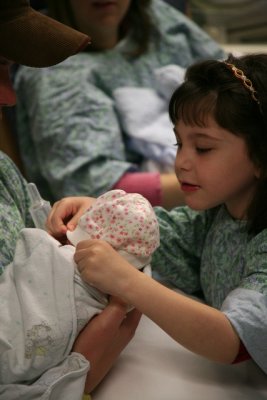 Ella Helps Put Kaylas Hat On_6941.jpg
