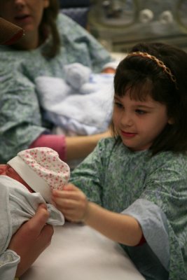 Ella Helps Put Kaylas Hat On_6945.jpg
