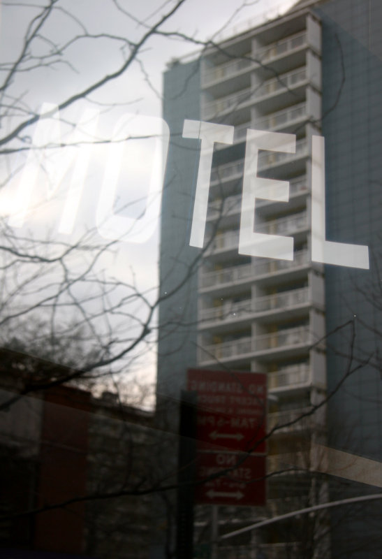 Motel Sign  with Window Reflection of LaGuardia Place Residences