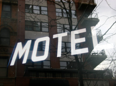 Motel Sign  with Window Reflection of LaGuardia Place Residences