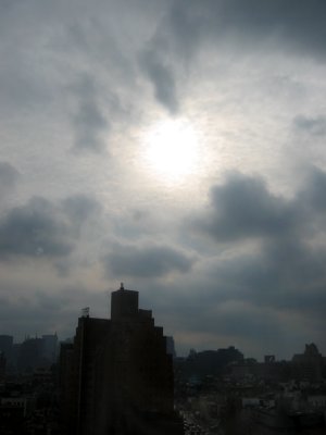 Sun in Clouds - Southwest Skyline through a Smudgy Window