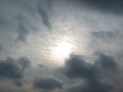 Sun in Clouds - Southwest Skyline through a Smudgy Window