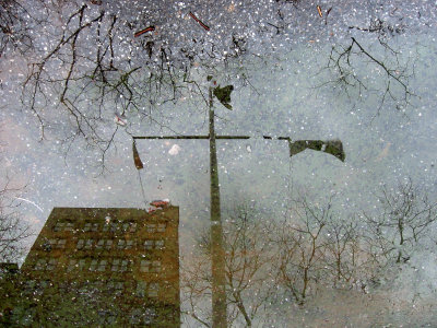 Flagpole & Skyline Reflection in a Puddle of Water