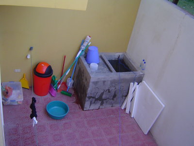 Our back yard is a tiny walled in area with a Pila (washboard/water storage) a cistern, and a water pump.