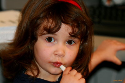 PUTTING ON LIPSTICK OVER THE CHOCOLATE COOKIE SHE JUST ATE!