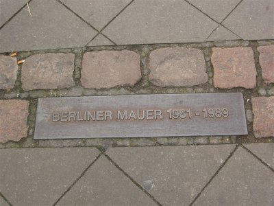 Berliner Mauer 1961-1989  (the bricks alone the road and the sidwalk is where the Berlin Wall was standing)