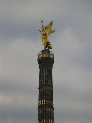 the larger gilded lady on top stands 8.3m tall, predictably represents the goddess of Victory