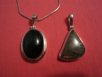 2 pendants,  on the left is a black onyx and the one on the right is a labradorite