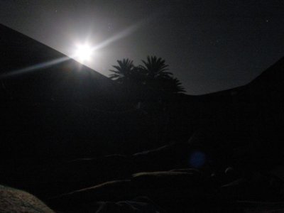 this is the moon coming up over the sand dunes