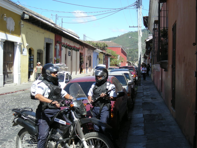 Private security wearing light Class II body armor and carrying the ubiquitous  Doce for interpersonal conflict resolution.