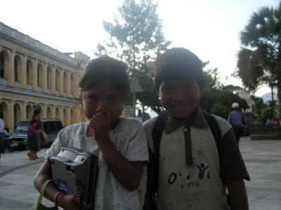Telephone girl and shoeshine boy. You can get Maya girls to crack a smile, impossible with Maya women who avoid eye contact.