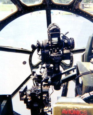 View through plexiglass nose of B-29 with Norden bombsight in foreground.