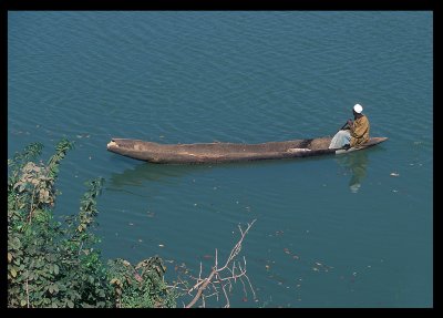 Going down River Gambia in wooden canoe