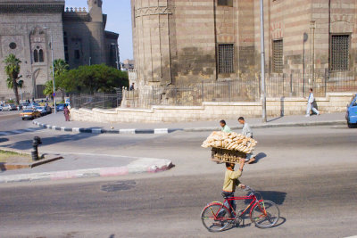 These guys ride around with enormous sheets of wood carrying bread on their heads.