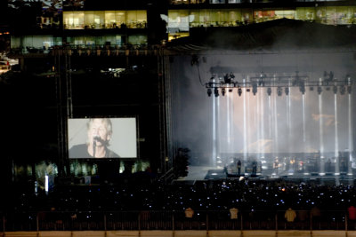 Roger on the video screen, office windows in the background