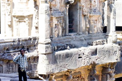 A guy standing outside the second floor entrance to the Shiva Temple