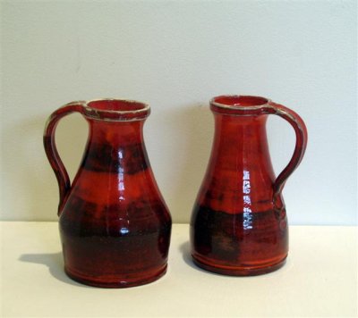 two earthenware pitchers with red glaze