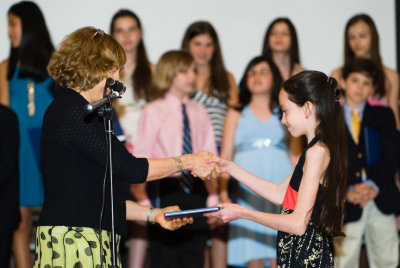 Receiving her diploma.