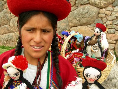 young peruvian woman selling dolls.Peru