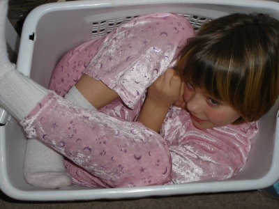 Kaitlyn in a laundry basket