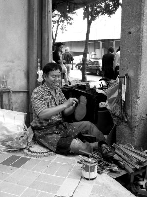 Street Cobbler Happy in his Work