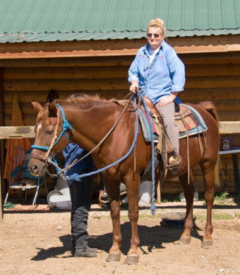 zP1010839 Dora ready to ride - as wranger checks horse and saddle.jpg