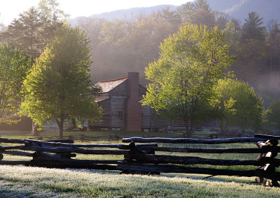 Pioneer cabins in the lingering fog