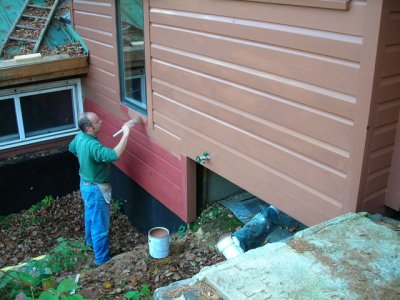 100906-N-1064 painting the new siding.JPG