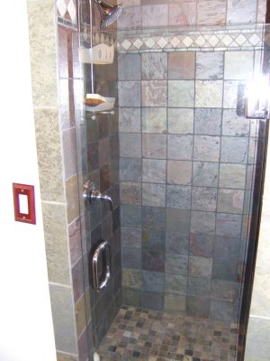 The showe was redone in slate tiles and the ceiling was raised