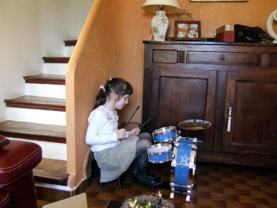 Louise tries the drums.